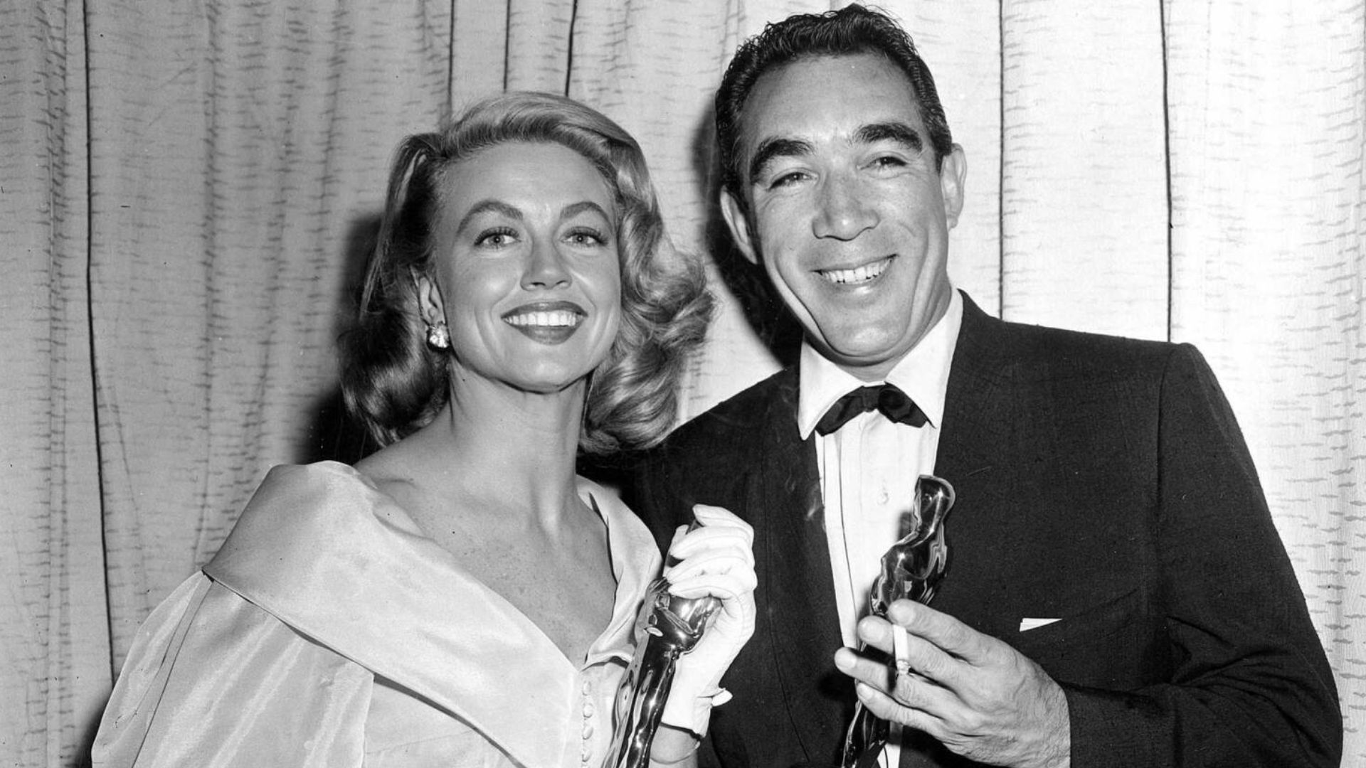 Anthony Quinn And His Wife Smiling Holding Awards In Hand