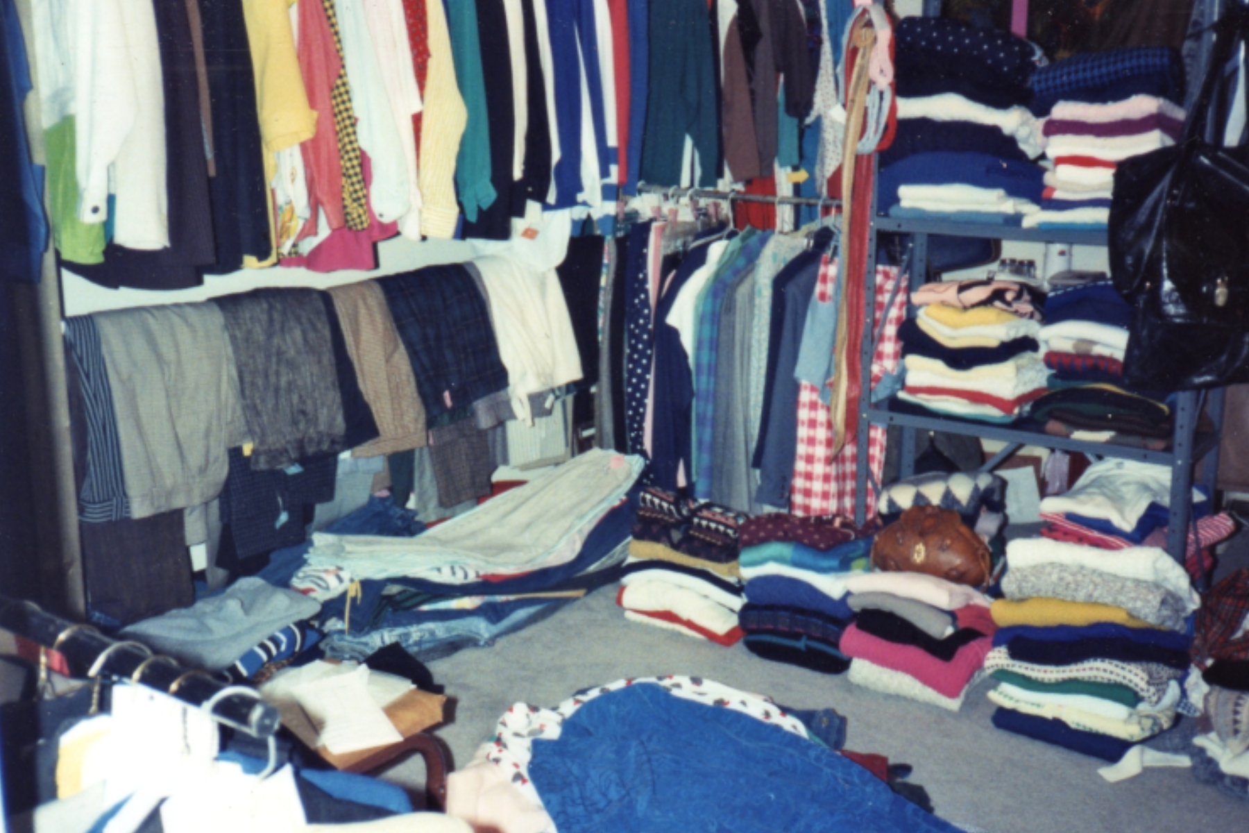 Different styles of clothes displayed at a garage sale