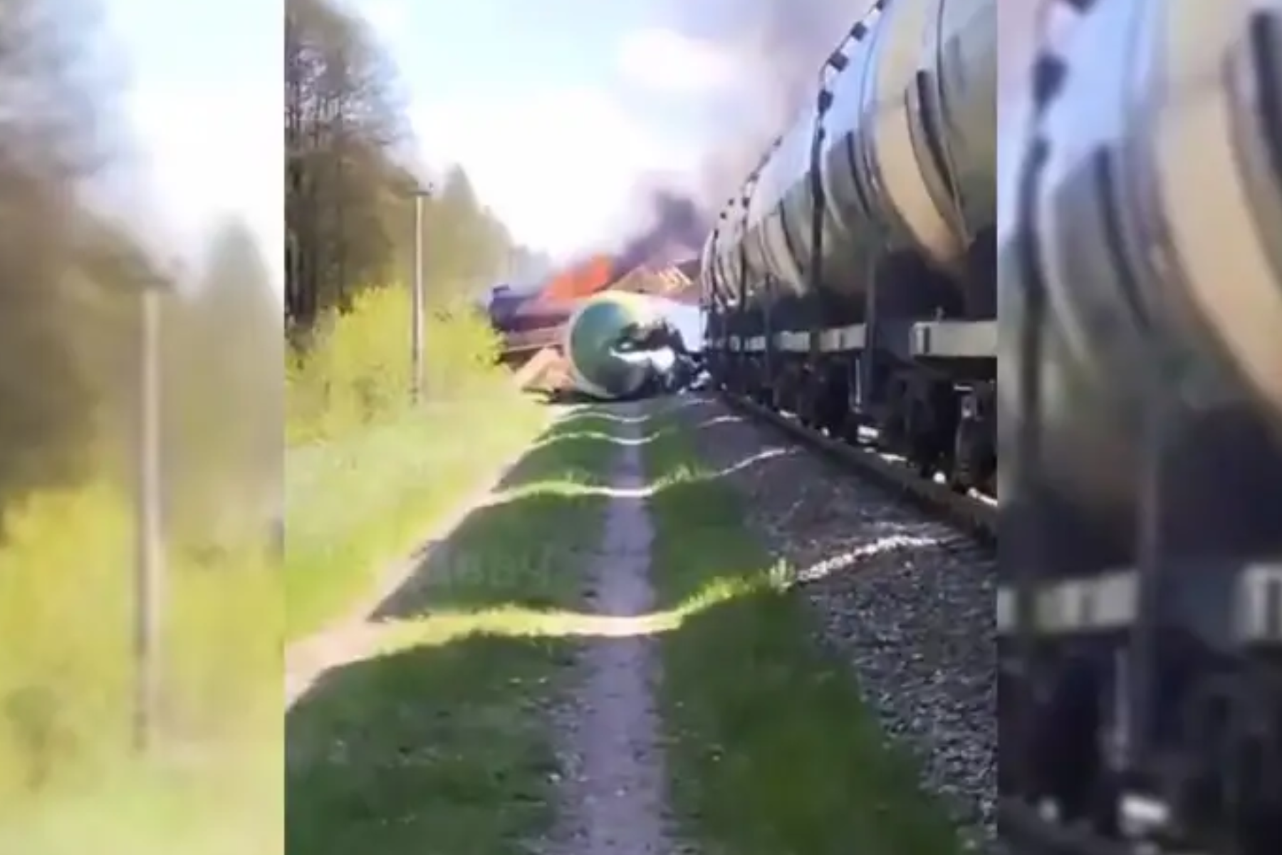 A video frame showing a derailed train that collided with an unknown explosive device