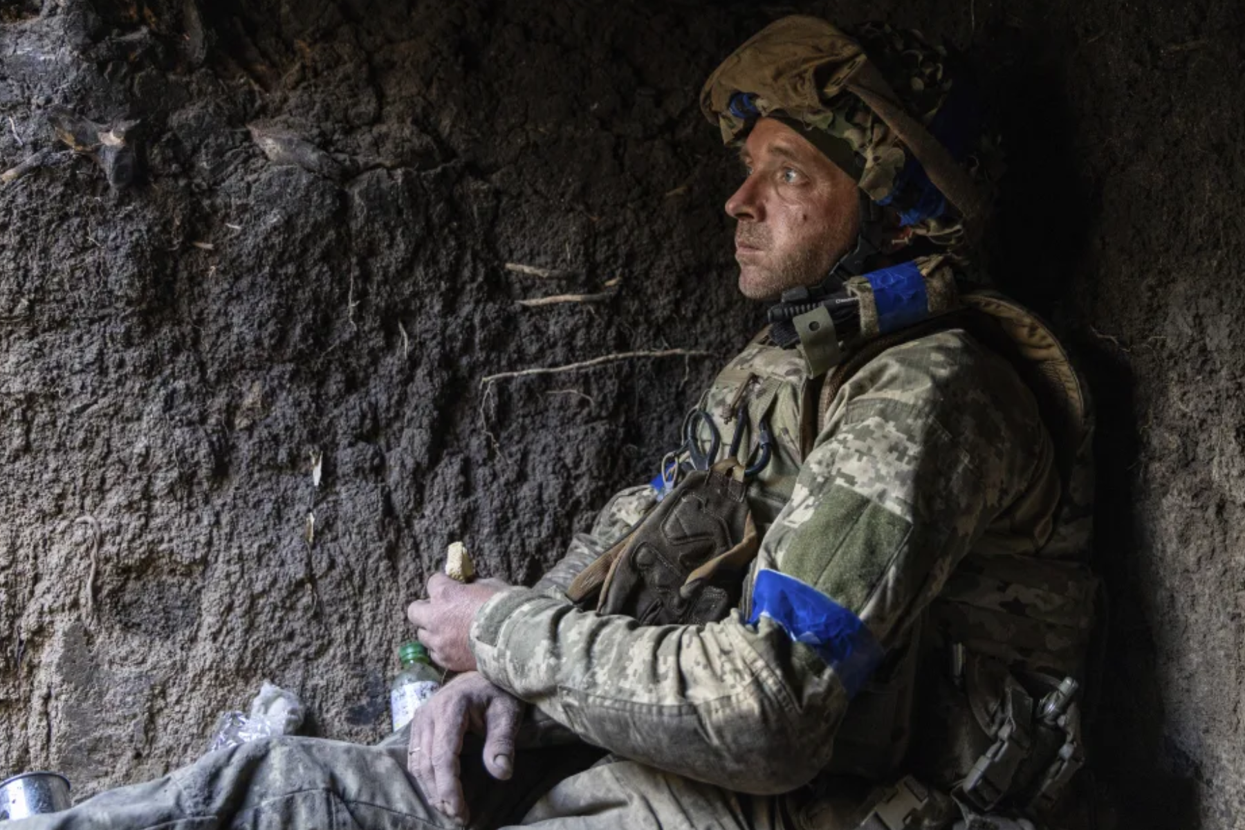 A Ukrainian serviceman from the 3rd Assault Brigade known as 'Sheva' eats a slice of bread